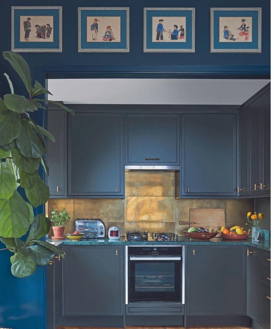 Dark blue kitchen with gold backsplash