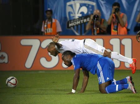 Aug 22, 2015; Montreal, Quebec, CAN; Philadelphia Union defender Fabinho (33) jumps over Montreal Impact forward Didier Drogba (11) during the second half at Stade Saputo. Jean-Yves Ahern-USA TODAY Sports
