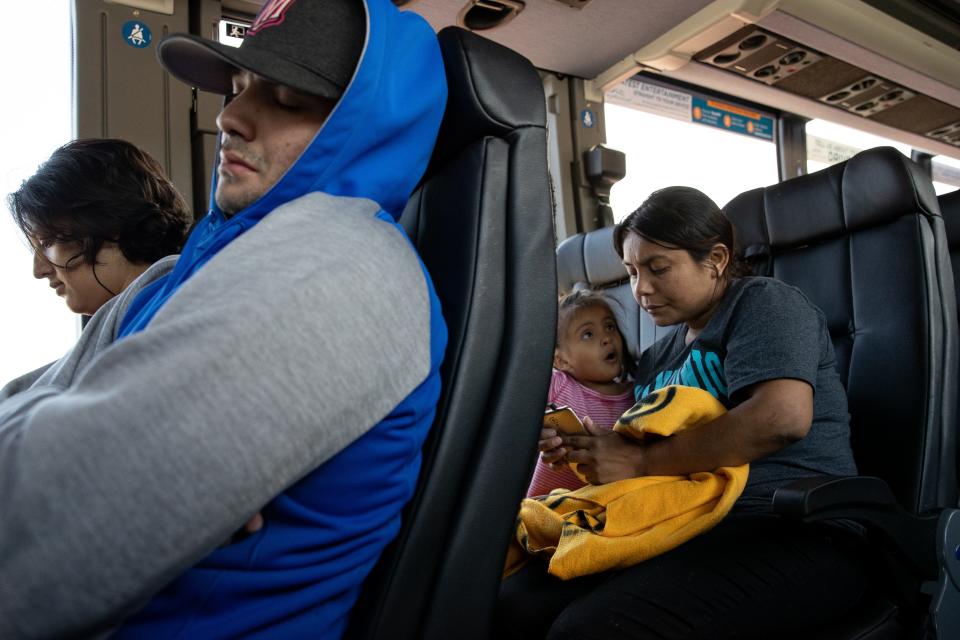 PHOENIX – Delmy López, 31, a migrant from Honduras, sends a message on her phone while on a bus at the Phoenix Greyhound station on June 29, 2019.