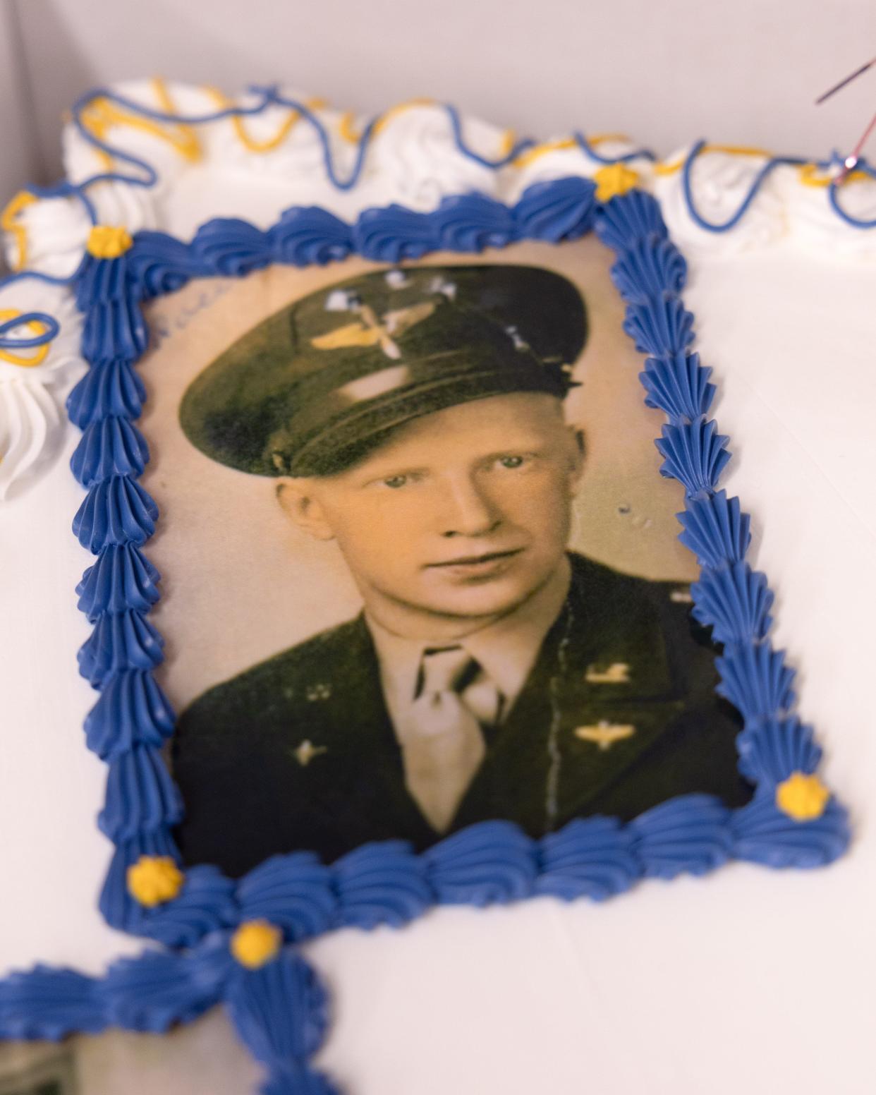 A photo of a young Vernon Roen adorns a 100th birthday cake in his honor at a party Saturday, Feb. 10, 2024, at the Ravenna VFW.
