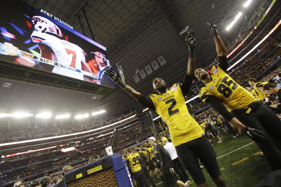 Missouri wide receiver L'Damian Washington (2) and wide receiver Marcus Lucas (85) cheer during the end of the second half of the Cotton Bowl NCAA college football game against Oklahoma State, Friday, Jan. 3, 2014, in Arlington, Texas. Missouri won 41-31. (AP Photo/Tim Sharp)