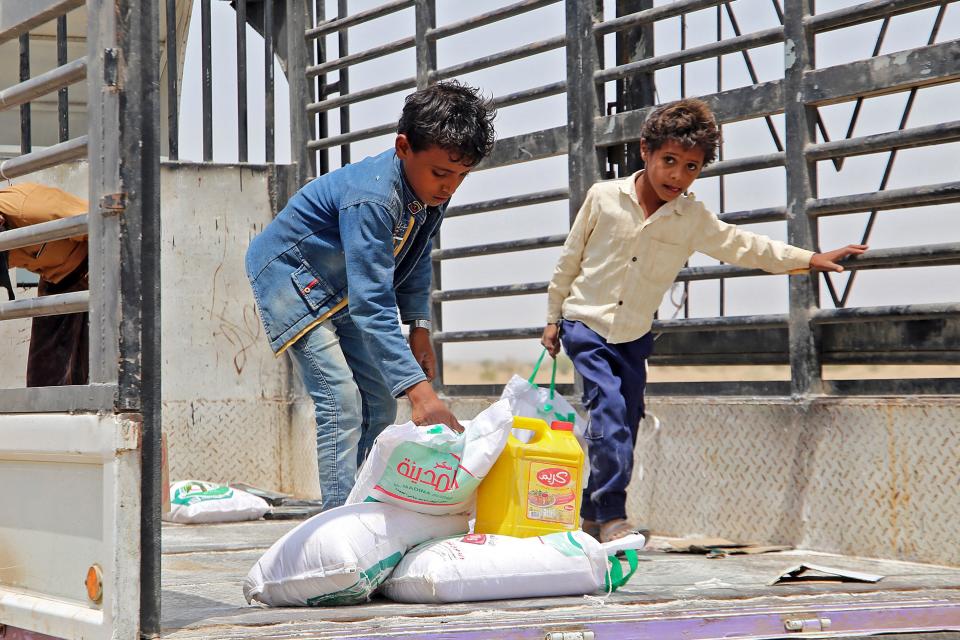 Displaced children receive food aid at a camp in the Hodeidah province of Yemen (Khaled Ziad /AFP/Getty)