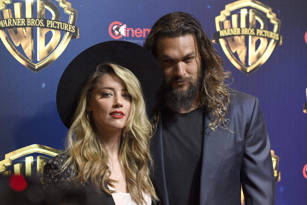 Amber Heard, left, and Jason Momoa, cast members in the upcoming film "Aquaman," arrive at the Warner Bros. presentation at CinemaCon 2018, the official convention of the National Association of Theatre Owners, at Caesars Palace on Tuesday, April 24, 2018, in Las Vegas. (Photo by Chris Pizzello/Invision/AP)