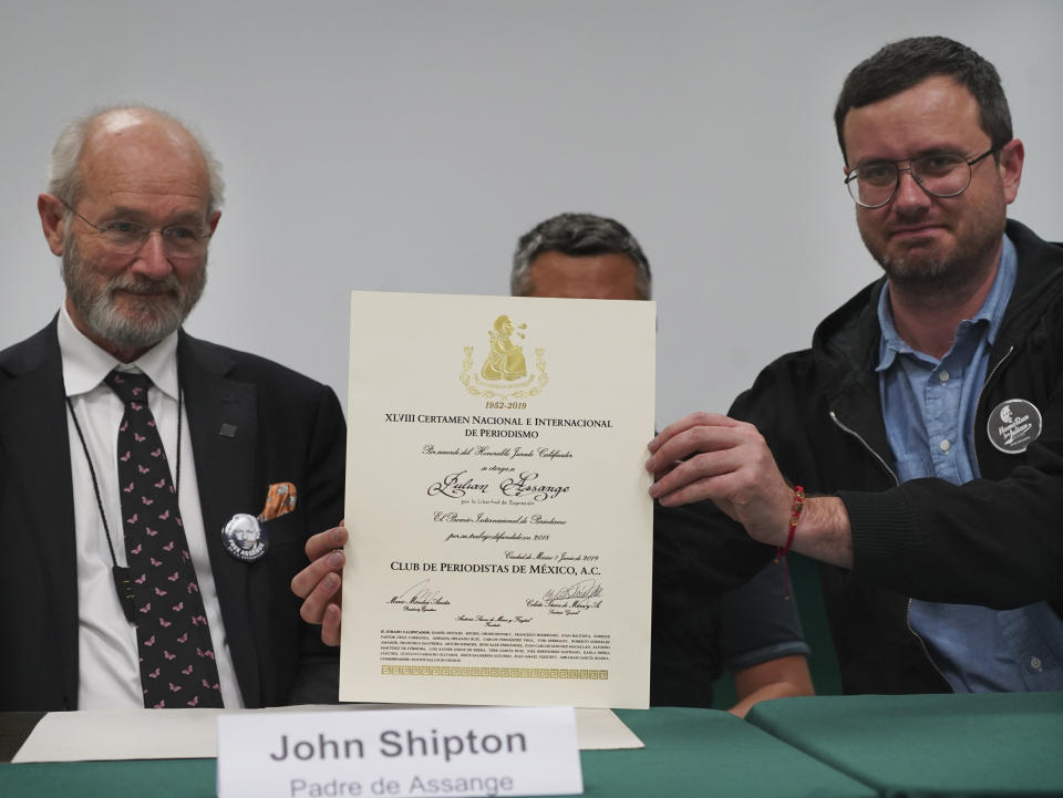 John Shipton and Gabriel Shipton, Julian Assange's father and brother respectively, display a diploma awarded by Mexico's Julian journalists' club during an event sponsored by the Mexican ruling party Morena, at the Telefónica Union headquarters, titled "Freedom for Julian Asange: A Global Struggle ," in Mexico City, on Wednesday, September 14, 2022 (AP Photo/Marco Ugarte)