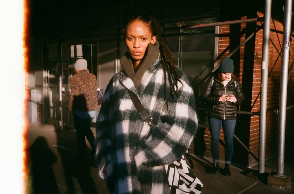 Aighewi waits for a car to bring her to a quick casting in between her Longchamp and Brandon Maxwell shows.