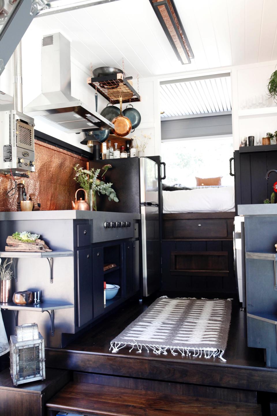 Bela Fishbeyn's tiny house's kitchen with rug and dark wood floors