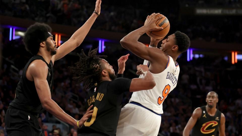 Apr 21, 2023; New York, New York, USA; New York Knicks guard RJ Barrett (9) drives to the basket against Cleveland Cavaliers center Jarrett Allen (31) and guards Darius Garland (10) and Caris LeVert (3) during the fourth quarter of game three of the 2023 NBA playoffs at Madison Square Garden.