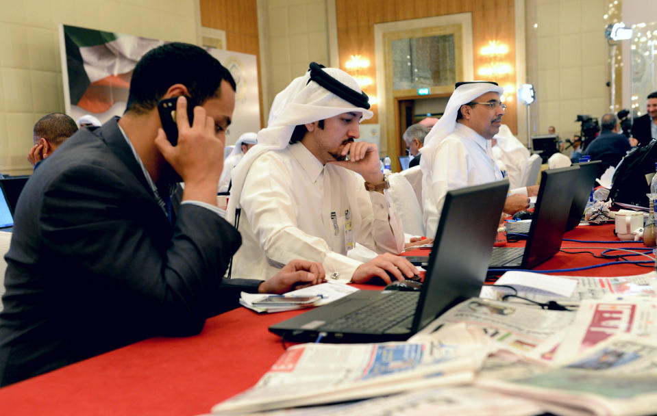 Journalists work at the Kuwait Ministry of Information's press center in the Al Raya ballroom in Kuwait City on Monday, March 24, 2014. The country is preparing to host the annual Arab League Summit scheduled for March 25 and 26.(AP Photo/Nasser Waggi)