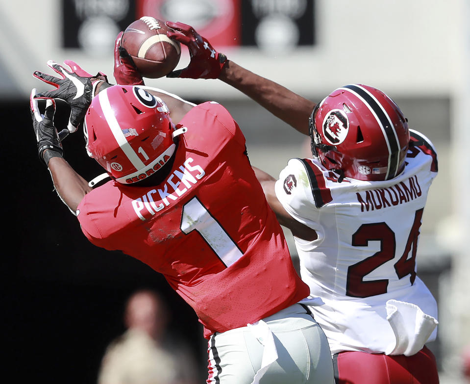 South Carolina defensive back Israel Mukuamu intercepts a pass intended for Georgia wide receiver George Pickens during the second quarter of an NCAA college football game, Saturday, Oct., 12, 2019, in Athens, Ga. Mukuamu returned the ball for a touchdown. (Curtis Compton/Atlanta Journal-Constitution via AP)