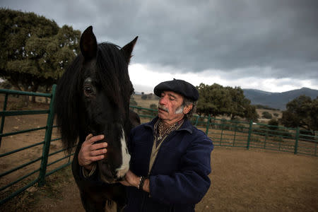 Fernando Noailles, emotional therapist, stands with his horse named Madrid in Guadalix de la Sierra, outside Madrid, Spain, December 9, 2017. Noailles uses his animals to help people suffering from stress and anxiety. REUTERS/Juan Medina