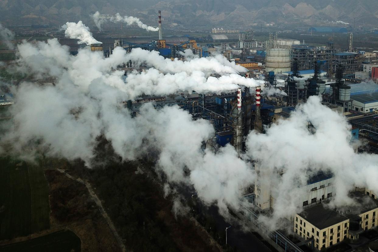 Smoke and steam rise from a coal processing plant in Hejin, in central China's Shanxi Province. (Photo: AP Photo/Sam McNeil)