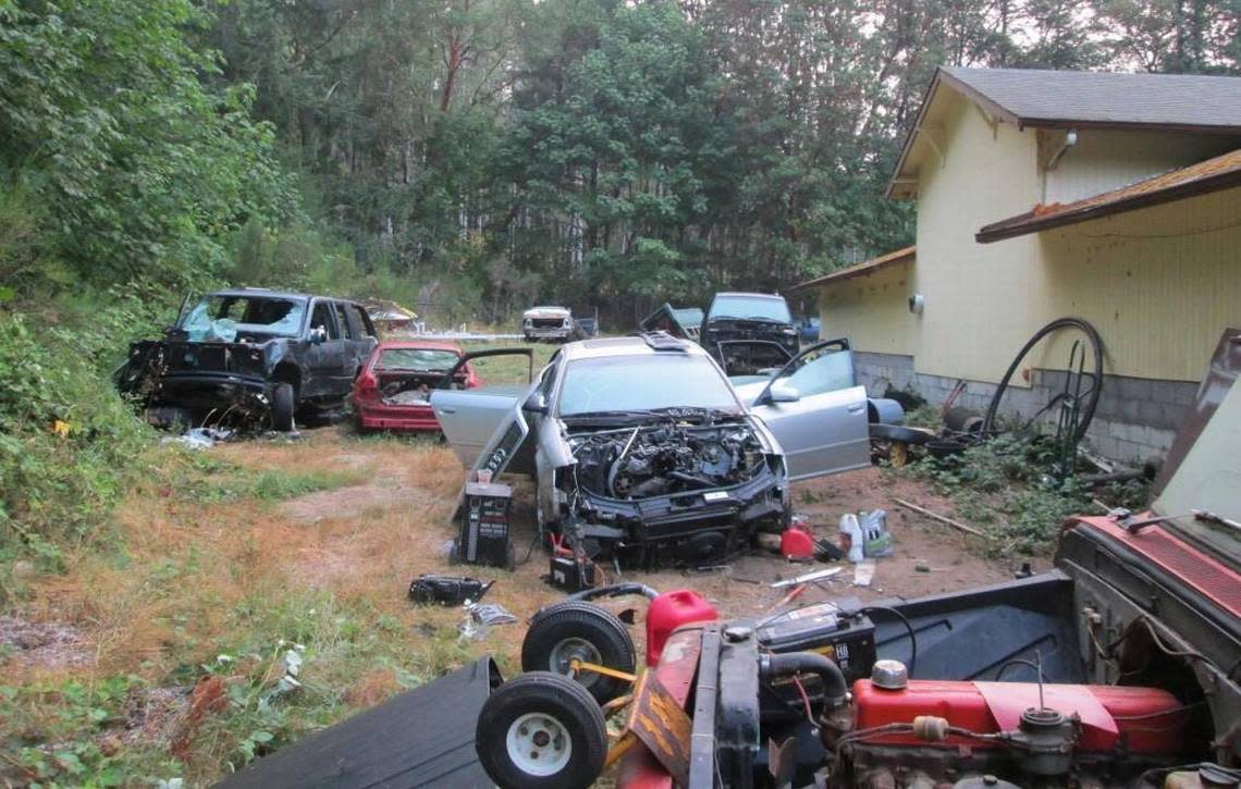 Vehicles and other items litter this property on Chapman Drive NW in Gig Harbor which police say was being used as a chop shop.