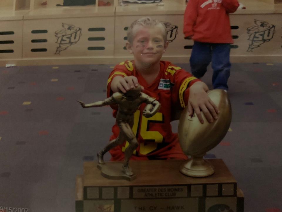 A young Beau Coberley gets an up-close-and-personal look at the Cy-Hawk trophy a 2007 win against Iowa.