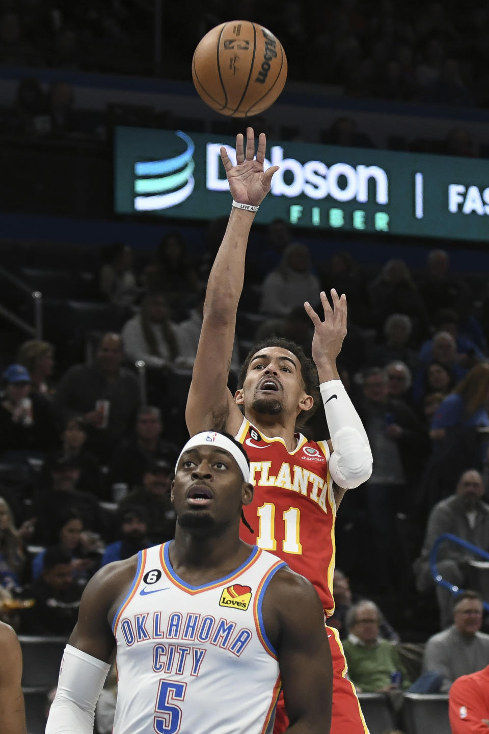 Atlanta Hawks guard Trae Young (11) shoots the ball over Oklahoma City Thunder forward Luguentz Dort (5) in the first half of an NBA basketball game, Wednesday, Jan. 25, 2023, in Oklahoma City. (AP Photo/Kyle Phillips)