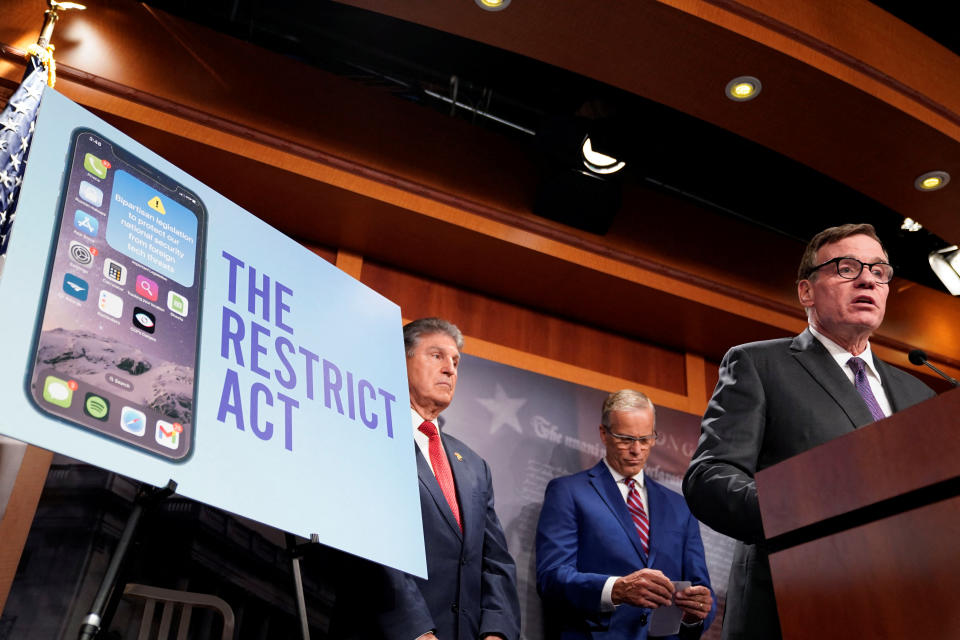 U.S. Senator Mark Warner (D-VA) speaks as U.S. Senator Joe Manchin (D-WV) looks on during a press conference to unveil legislation that would allow the Biden administration to 