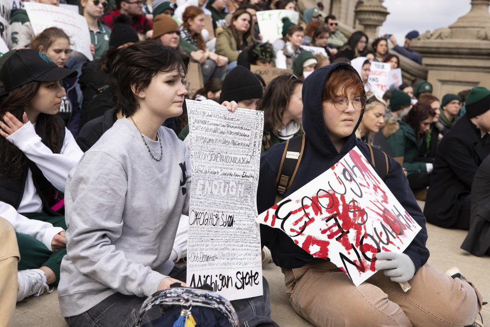 Demonstrators hold signs to protest gun violence at a student sit-in at the Michigan Capitol building following Monday's mass shooting at Michigan State University, Wednesday, Feb. 15, 2023, in Lansing, Mich. (Brice Tucker/The Flint Journal via AP)