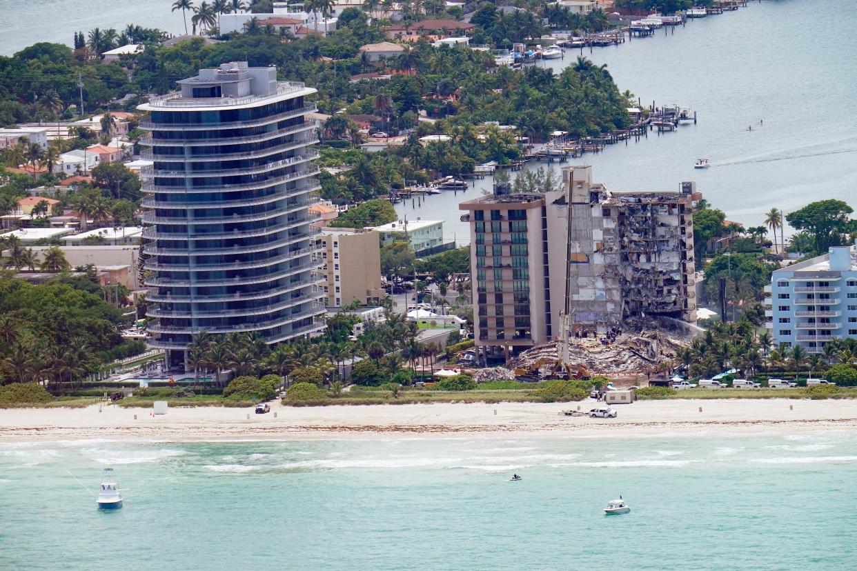 Workers search in the rubble at the Champlain Towers South Condo, Saturday, June 26, 2021, in Surfside, Fla. More than 150 people were still unaccounted for two days after Thursday's collapse, which killed at least nine.