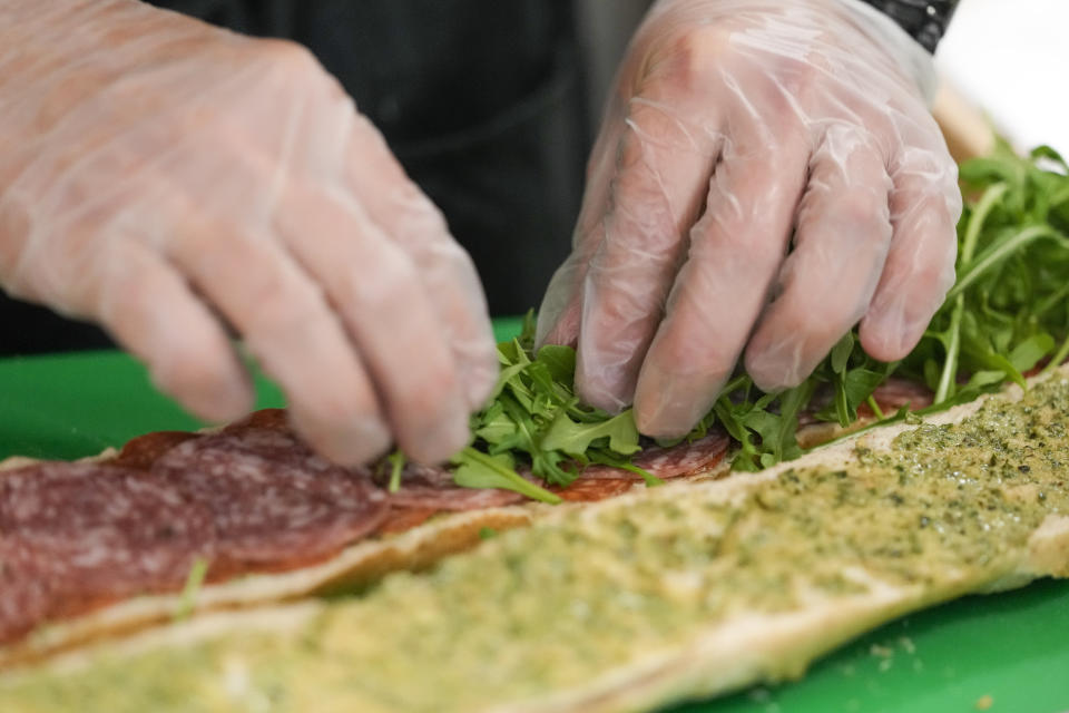 Chef Josh Gjersand prepares a sandwich with homemade pesto aioli and layered with Toscano salami, Monterey Jack and fresh arugula for Mount Diablo High School students to try during a taste test in Concord, Calif., Friday, Jan. 13, 2023. (AP Photo/Godofredo A. Vásquez)