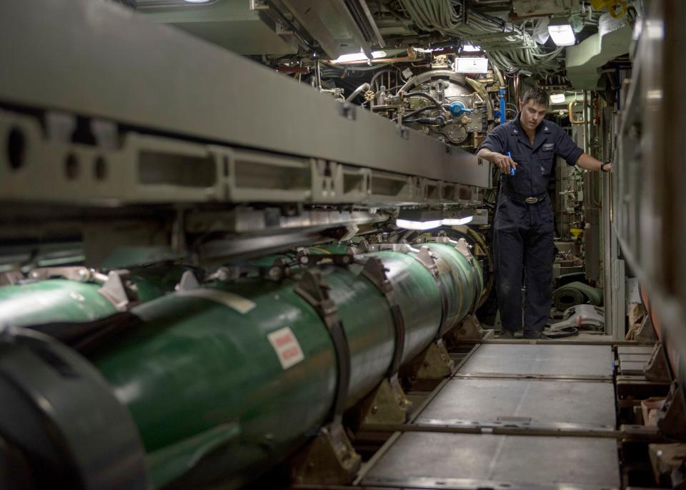Sailors assigned to Los Angeles-class fast-attack submarine USS Jefferson City (SSN 759) load a Mark 48 Advanced Capability (ADCAP) torpedo during Exercise Rim of the Pacific (RIMPAC) 2020 sink exercise (SINKEX).