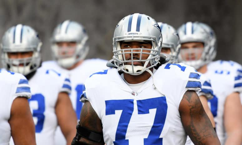 A closeup of Tyron Smith walking onto the field with his Dallas Cowboys teammates.