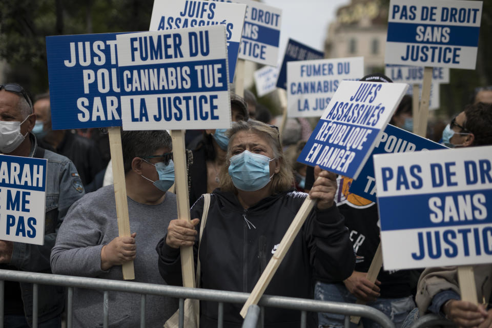 A protester sings chants while holding a sign that reads "murdered Jews, republic in danger" during a demonstration in Marseille, southern France, Sunday, April 25, 2021. Crowds gathered Sunday in Paris and other French cities to denounce a ruling by France's highest court that the killer of Jewish woman Sarah Halimi was not criminally responsible and therefore could not go on trial. (AP Photo/Daniel Cole)
