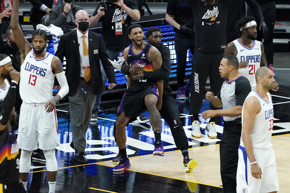 Phoenix Suns' Cameron Payne, center left, celebrates with teammates during the second half of Game 2 of the NBA basketball Western Conference Finals against the Los Angeles Clippers, Tuesday, June 22, 2021, in Phoenix. (AP Photo/Matt York)