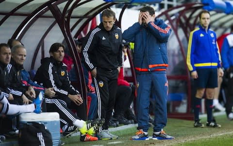 Gary Neville holds his head in his hands while Valencia manager - Credit: getty images