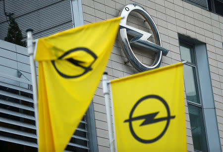 FILE PHOTO: Flags with the Opel logo are seen at the Opel headquarters in Ruesselsheim, Germany November 9, 2017. REUTERS/Ralph Orlowski/File Photo