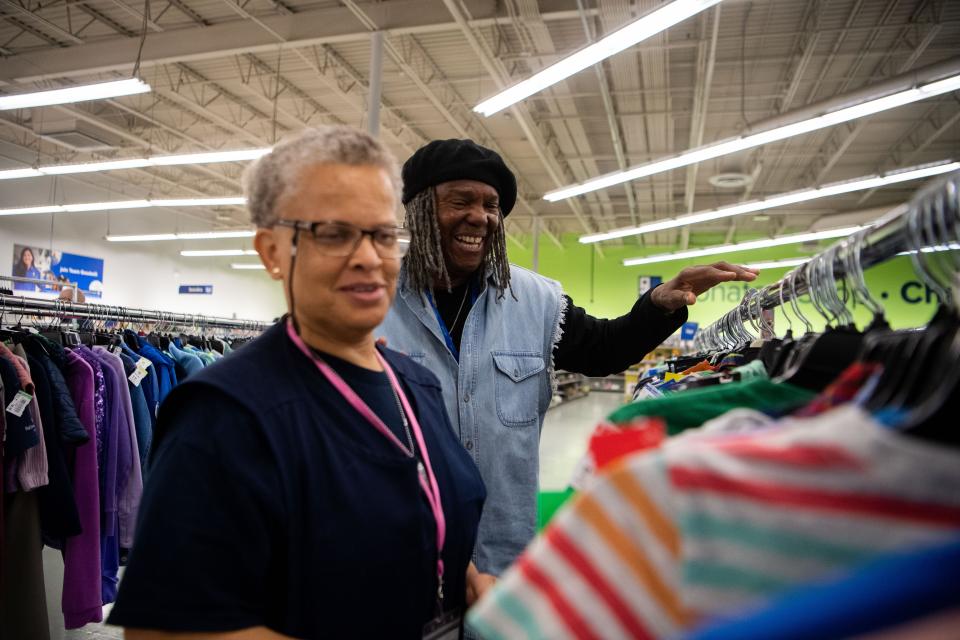 Jonathan Kelsey helps Missy Mayes pick out the orange tags clothes from the racks while working at Goodwill in Nashville, Tenn., Wednesday, April 3, 2024.
