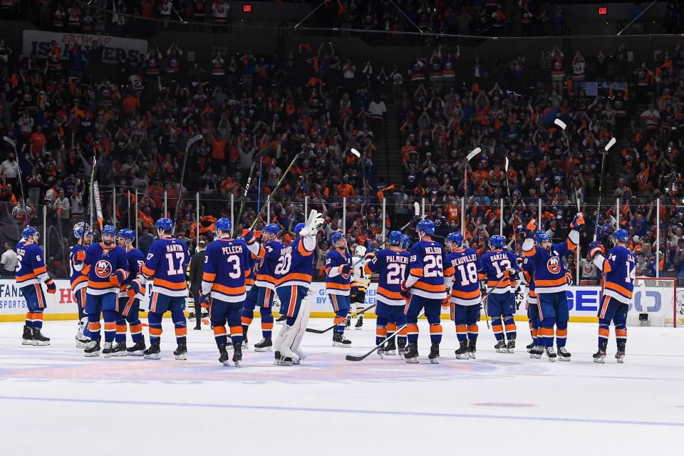 The New York Islanders salute the crowd after defeating the Pittsburgh Penguins in the first round of the 2021 Stanley Cup Playoffs.