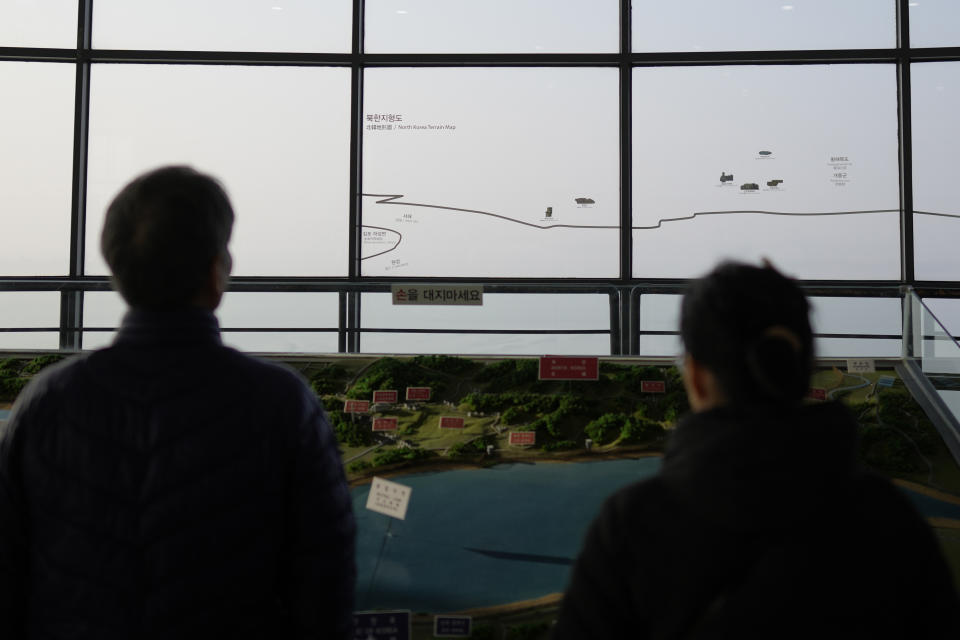 Visitors look at the North Korean side from the unification observatory, in Paju, South Korea, Friday, Jan. 5, 2024. North Korea fired artillery rounds Friday near its disputed sea boundary with South Korea in violation of a fragile 2018 military agreement, officials said, prompting the South to plan similar drills. (AP Photo/Lee Jin-man)