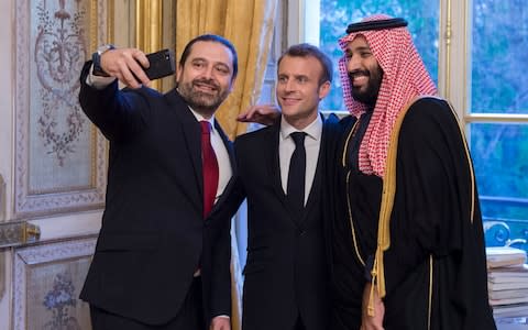 Lebanon's prime minister Saad Hariri takes a selfie with French President Emmanuel Macron (C) and Saudi Crown Prince Mohammed bin Salman (R) at The Elysee Palace in Paris - Credit: AFP