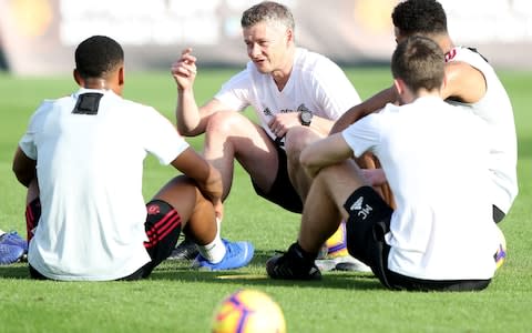 Ole Gunnar Solskjaer talks to his players in training - Credit: getty images