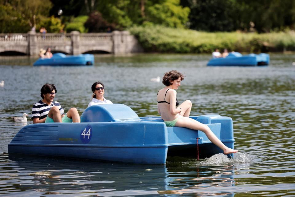 People ride in a pedalo in the sunshine in Hyde Park in London (AFP/Getty)