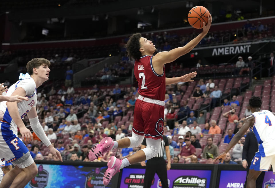 Richmond guard Jordan King (2) goes to the basket past Florida forward Alex Condon, left, during the second half of the NCAA college Orange Bowl Classic basketball game, Saturday, Dec. 9, 2023, in Sunrise, Fla. (AP Photo/Lynne Sladky)