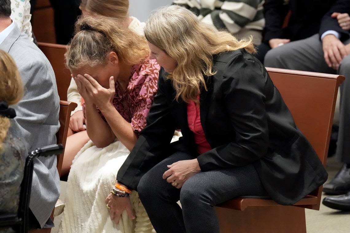 Debbie Hixon reaches out to her sister-in-law, Natalie Hixon, as they hear that Nikolas Cruz, who killed Debbie Hixon’s husband, Chris Hixon, Natalie Hixon’s brother, will not receive the death penalty at the trial of the Marjory Stoneman Douglas High School shooter on Oct. 13, 2022, at the Broward County Courthouse in Fort Lauderdale. Chris Hixon was the athletic director at the school and was killed trying to disarm Cruz on Feb. 14, 2018.