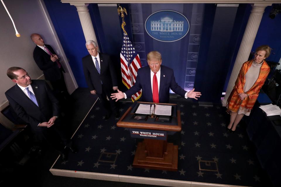 Trump, at Friday's White House briefing, vowed to help the uninsured with their coronavirus bills. But his plan will still leave many facing crippling medical expenses. (Win McNamee via Getty Images)