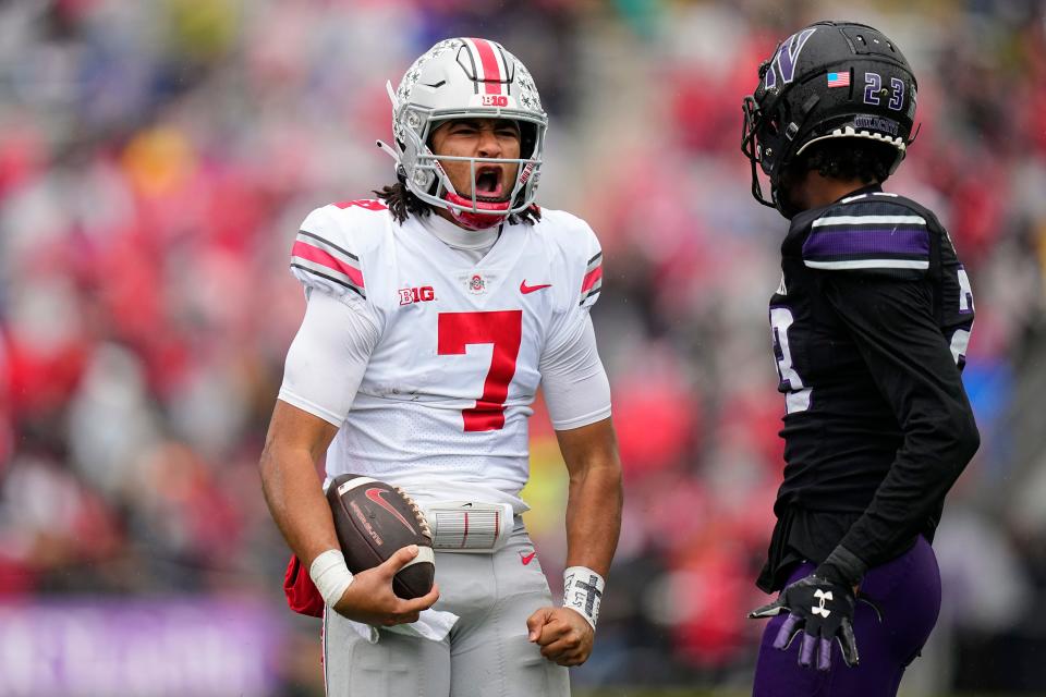 Ohio State Buckeyes quarterback C.J. Stroud (7) celebrates a first down in front of Northwestern Wildcats defensive back Devin Turner (23) during the first half of the NCAA football game at Ryan Field in Illinois on Nov. 5.