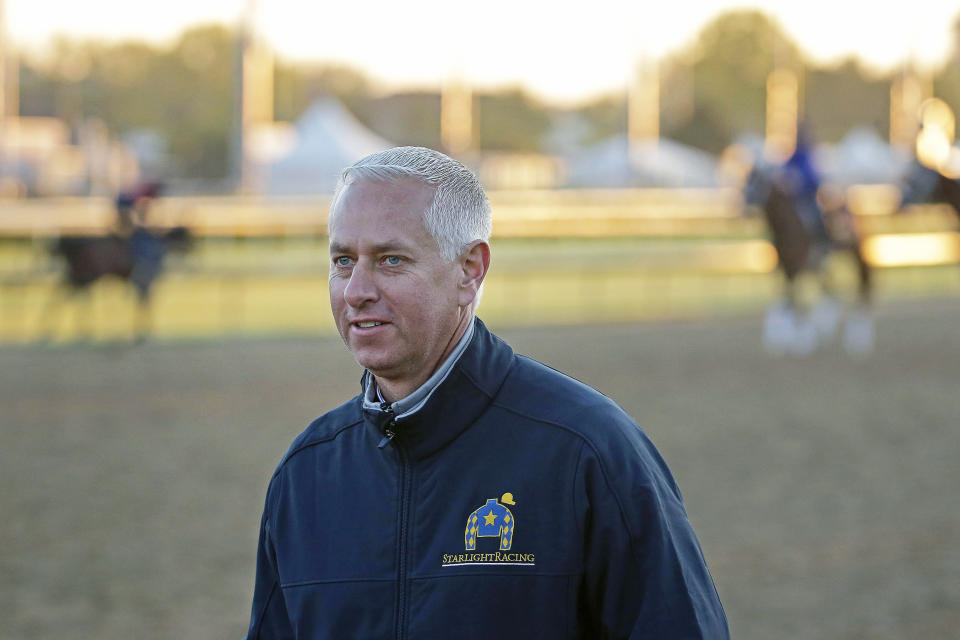 FILE - In this April 29, 2015, file photo, trainer Todd Pletcher watches horses on the track at Churchill Downs in Louisville, Ky. Triple Crown winner American Pharoah, seven-time Eclipse Award-winning trainer Todd Pletcher and 13-time champion steeplechase trainer Jack Fisher have been elected to the National Museum of Racing's Hall of Fame. The class of 2021 announced Wednesday, May 5, 2021, will be enshrined Aug. 6 in Saratoga Springs, New York, along with the 2020 inductees . (AP Photo/Charlie Riedel, File)