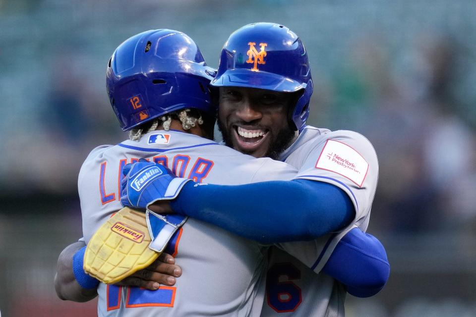 New York Mets' Francisco Lindor, left, celebrates with Starling Marte after hitting a grand slam against the Oakland Athletics during the second inning of a baseball game in Oakland, Calif., Friday, April 14, 2023.