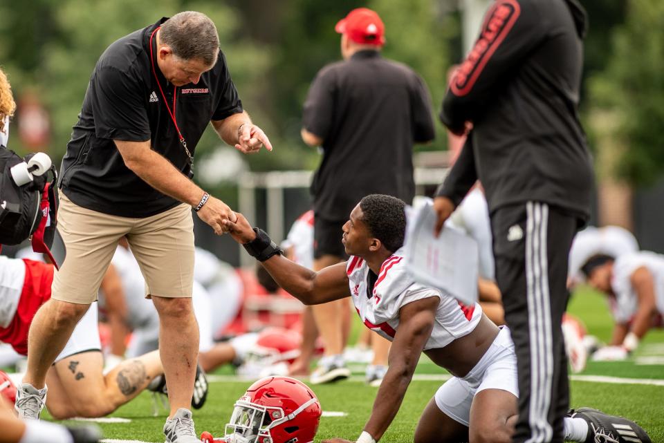 Rutgers football's first practice of training camp is held In Piscataway on Wednesday August 4, 2021. Head coach Greg Schiano shakes a player's hand during practice.