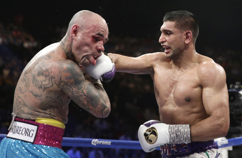 England's Amir Khan, right, connects with a hard right to the head of Luis Collazo in their silver welterweight title boxing fight Saturday, May 3, 2014, in Las Vegas. (AP Photo/Isaac Brekken)