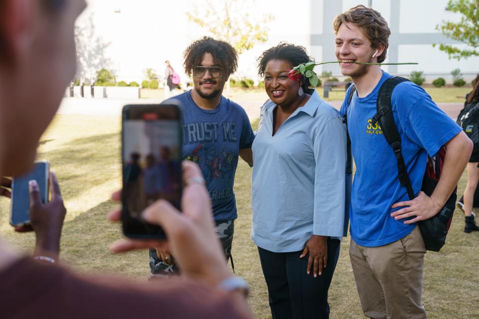 Democratic gubernatorial candidate Stacey Abrams poses for photos with students at Georgia State University in Atlanta.