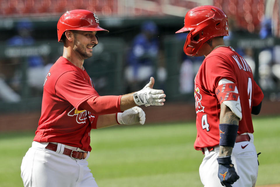FILE - In this Wednesday, July 22, 2020, file photo, St. Louis Cardinals' Paul DeJong, left, is congratulated by teammate Yadier Molina after hitting a two-run home run during the fifth inning of an exhibition baseball game against the Kansas City Royals in St. Louis. The Cardinals announced Tuesday, Aug. 4, 2020, that DeJong and Molina are among six of the players who have tested positive for coronavirus. The others are infielders Edmundo Sosa and Rangel Ravelo, and pitchers Junior Fernandez and Kodi Whitley.(AP Photo/Jeff Roberson, File)