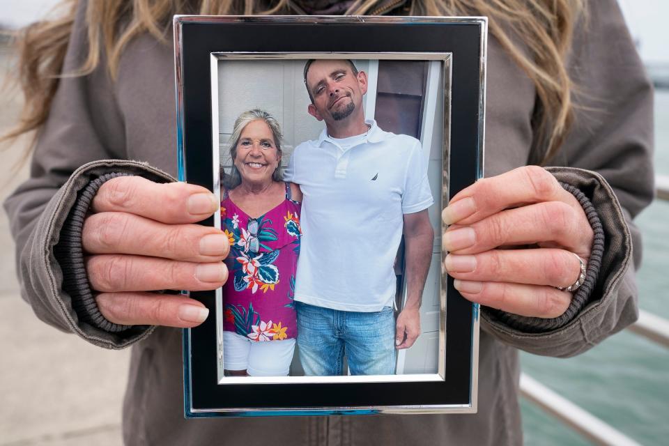 Katie Tanton of Port Huron holds a photo of her and her son, Bobby McIntyre, at Pine Grove Park in Port Huron on Friday, March 15, 2024. Tanton is the plaintiff in a lawsuit regarding issues with being able to contact her son, who is incarcerated at the St. Clair County Jail.