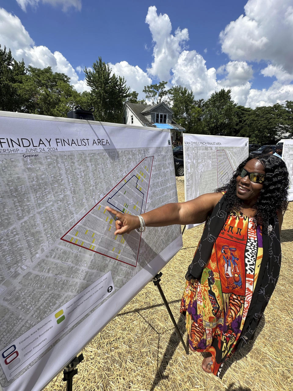 Donna Anthony, 63, points to a map of her neighborhood that was chosen to receive solar arrays, Monday, Jun 24, 2024, in east Detroit. The arrays would produce enough clean energy to offset the electricity used currently by 127 municipal buildings. Residents will receive funding to make their homes energy efficient. (AP Photo/Corey Williams)