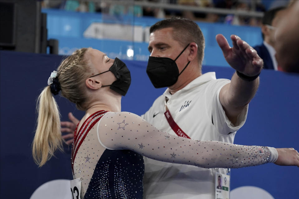 Jade Carey, of the United States, embraces her coach after performing on the floor exercise during the artistic gymnastics women's apparatus final at the 2020 Summer Olympics, Monday, Aug. 2, 2021, in Tokyo, Japan. (AP Photo/Ashley Landis)