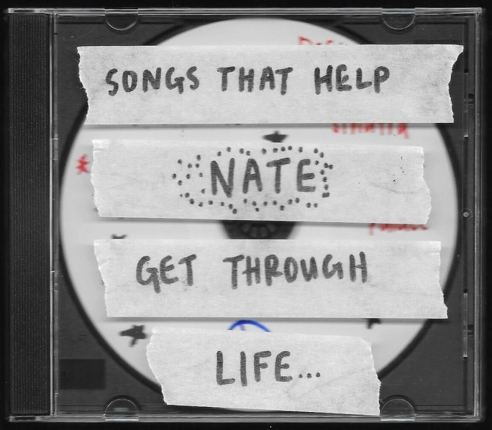 A CD case with handwritten labels reading "SONGS THAT HELP", "NATE", and "GET THROUGH LIFE..."