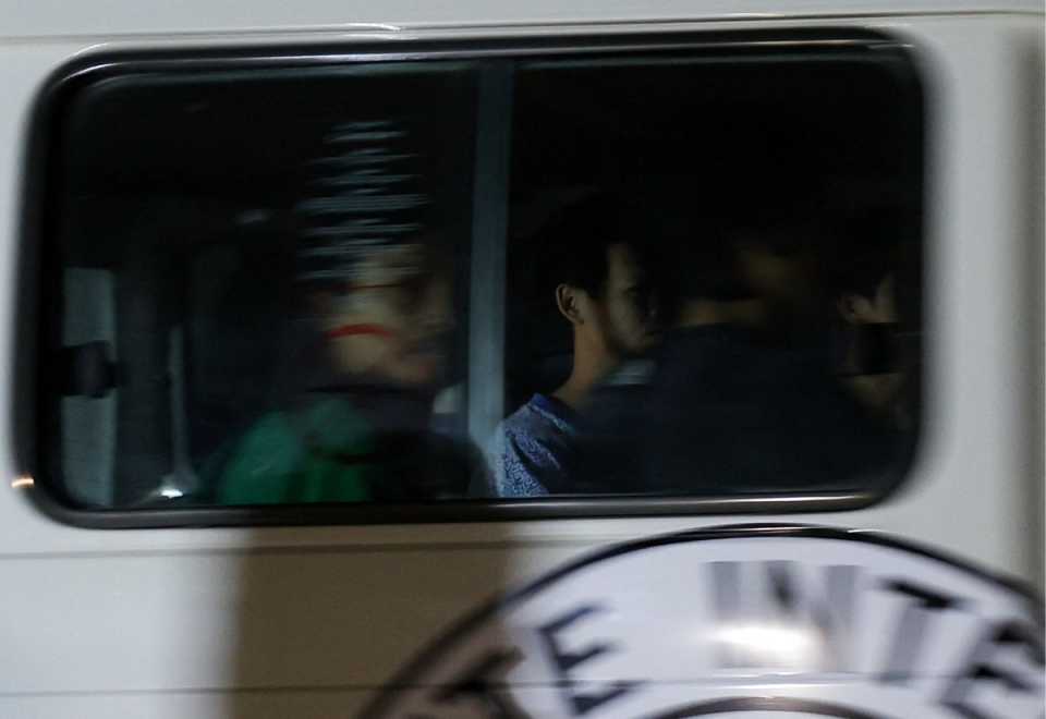 A Red Cross vehicle, believed to be carrying released hostages, crosses the border at Rafah (REUTERS)