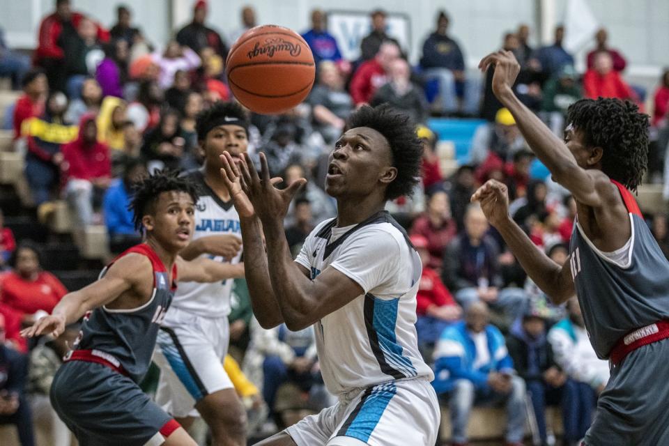 Flint forward D'Angelo Mays looks to grab a loose ball during a game against Beecher High.